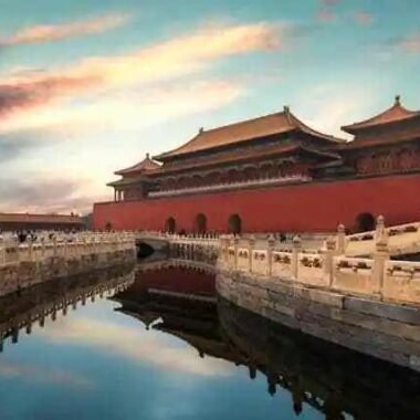 Forbidden City in Beijing, China - reflected in the city river at sunset