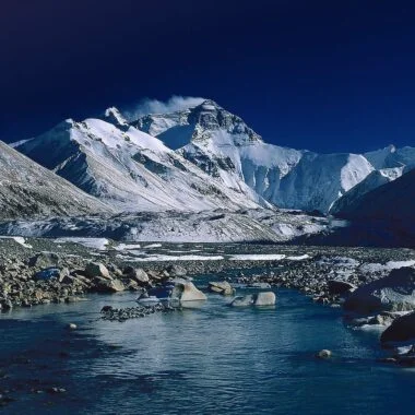 Mount Everest in Tibet - reflected in a small river