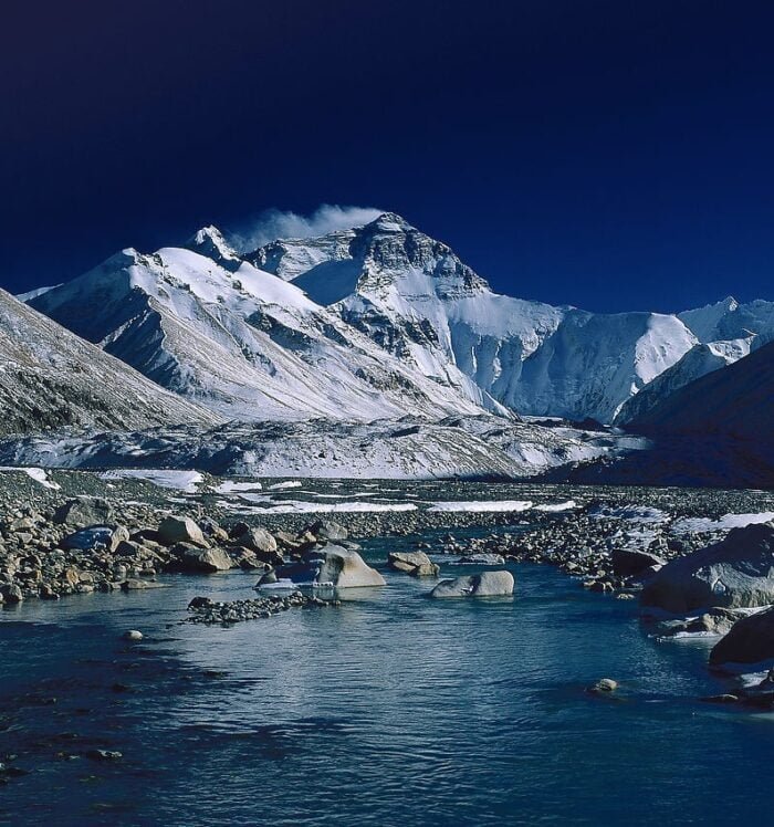 Mount Everest in Tibet - reflected in a small river