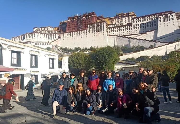 Group tour clients in front of Potala Palace on their way to Mount Everest