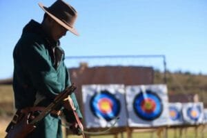 Travelers experiencing Tibetan culture at Jiemei Linka during the Peach Blossom Festival, including archery and tea making.