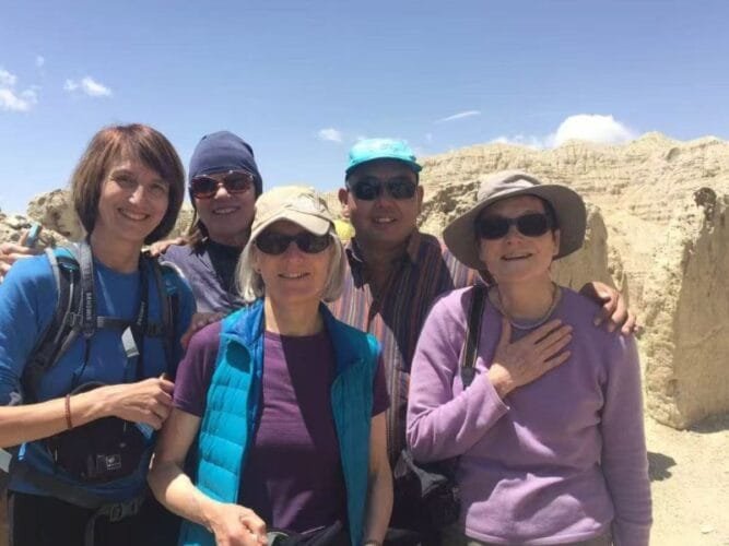 Travelers exploring the ancient Guge Kingdom ruins in western Tibet on their trip to Mt. Everest and Mt. Kailash